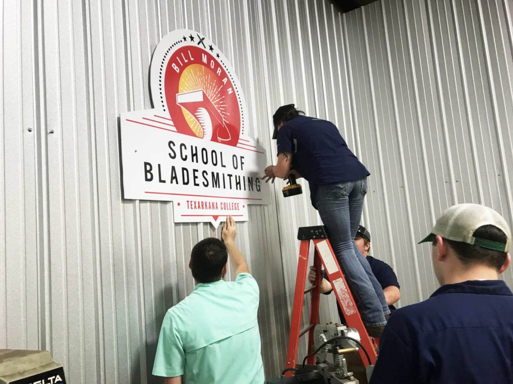 Logo being installed in the new bladesmith shop